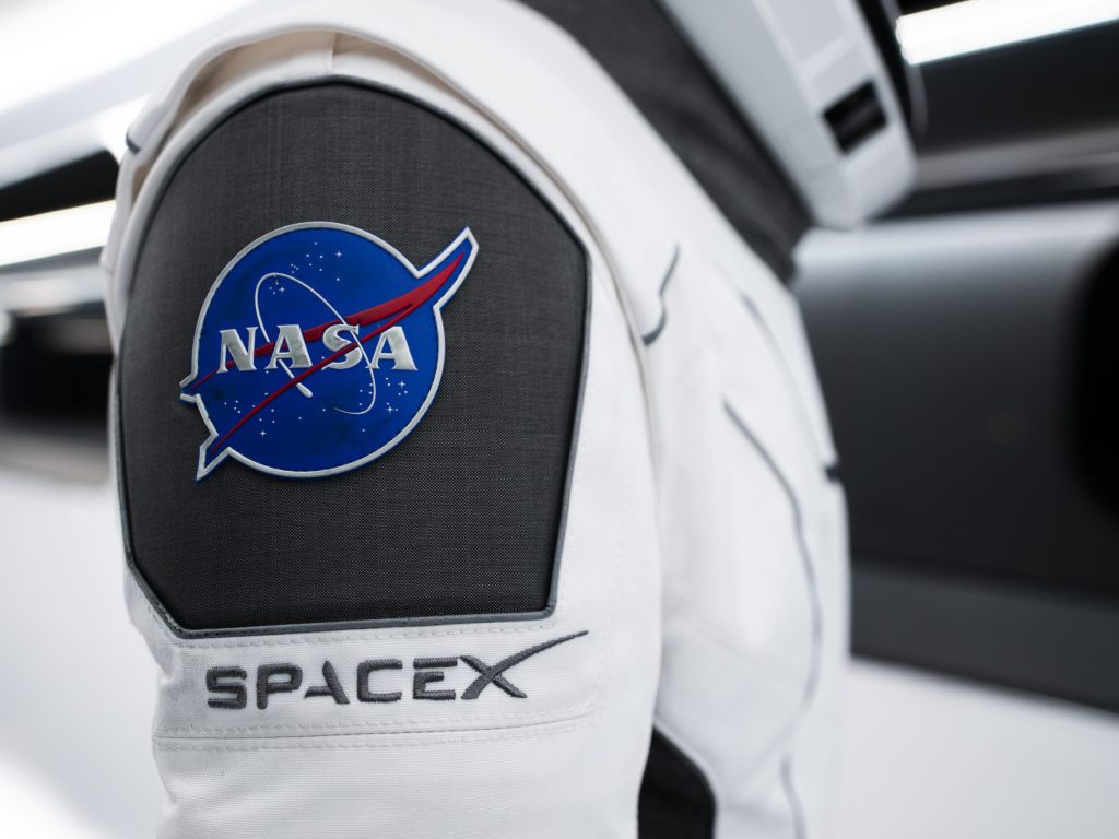 NASA’s SpaceX Crew-3 astronauts participate in a countdown dress rehearsal at the agency’s Kennedy Space Center in Florida on Oct. 28, 2021, to prepare for the upcoming Crew-3 launch. In this view is a close-up of the NASA and SpaceX embroidered emblems on the SpaceX spacesuit worn by NASA astronaut Kayla Barron. Barron is inside the crew access arm leading to the company’s Crew Dragon spacecraft during the rehearsal. The four-person crew will launch aboard the Crew Dragon atop the Falcon 9 on Oct. 31 to the International Space Station. Launch is targeted for 2:21 a.m. EDT from Pad 39A. Crew-3 is the third crew rotation flight to the space station for NASA’s Commercial Crew Program, and the first flight of a new Crew Dragon spacecraft.